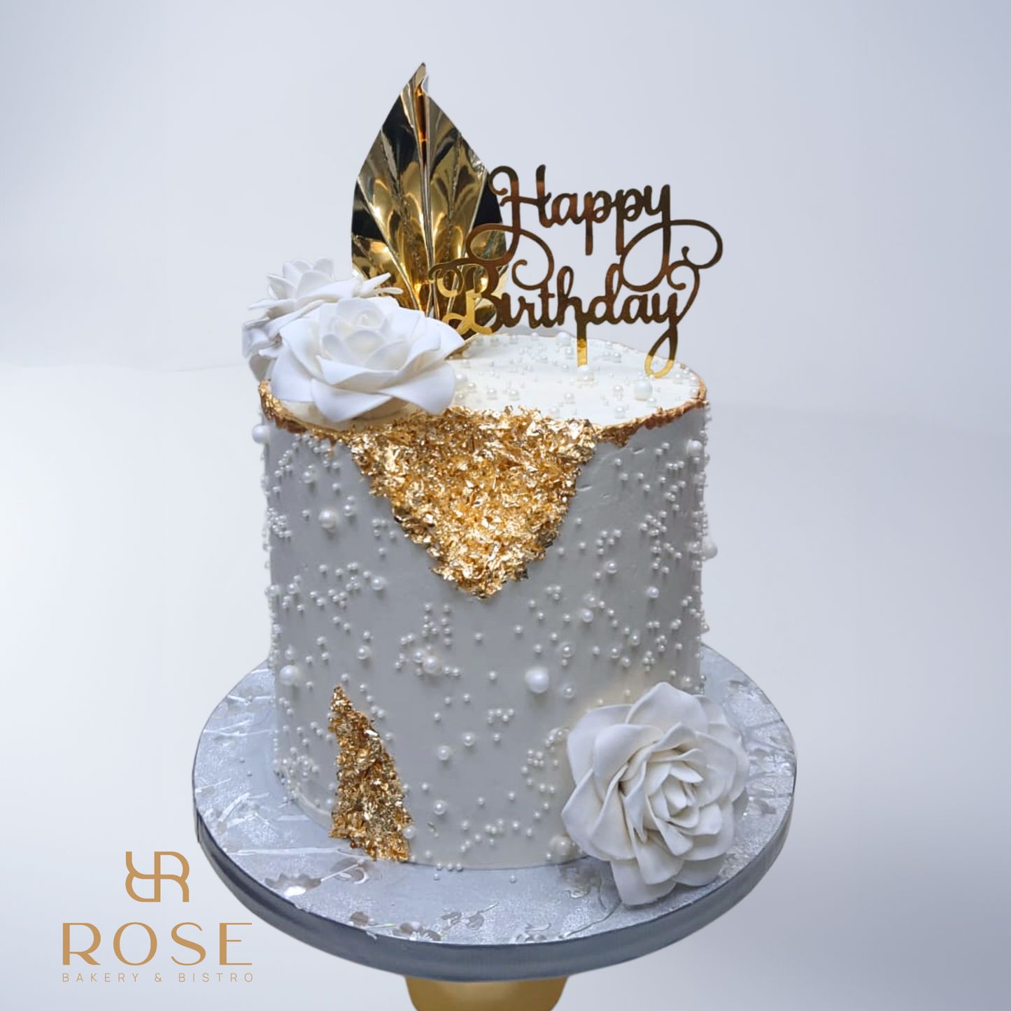 white roses and palm cake